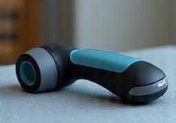 Theragun device on a massage table, ready for use.